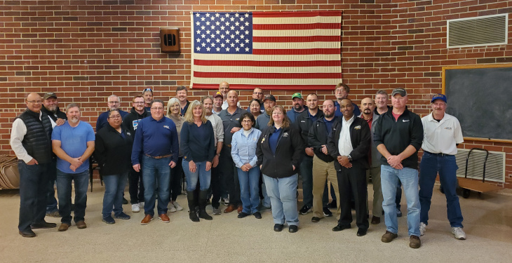 group of union members standing in front of american flag